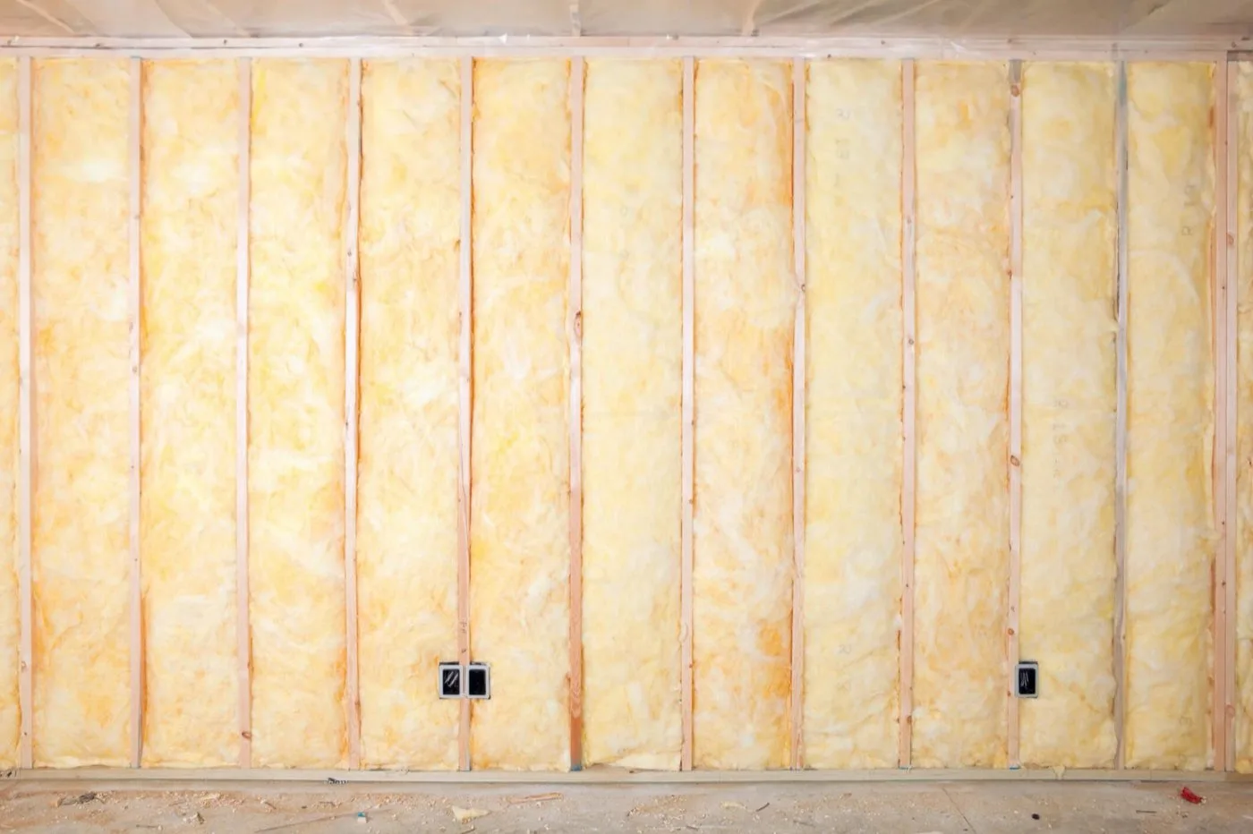 Fiberglass batt insulation fitted between wall framing
