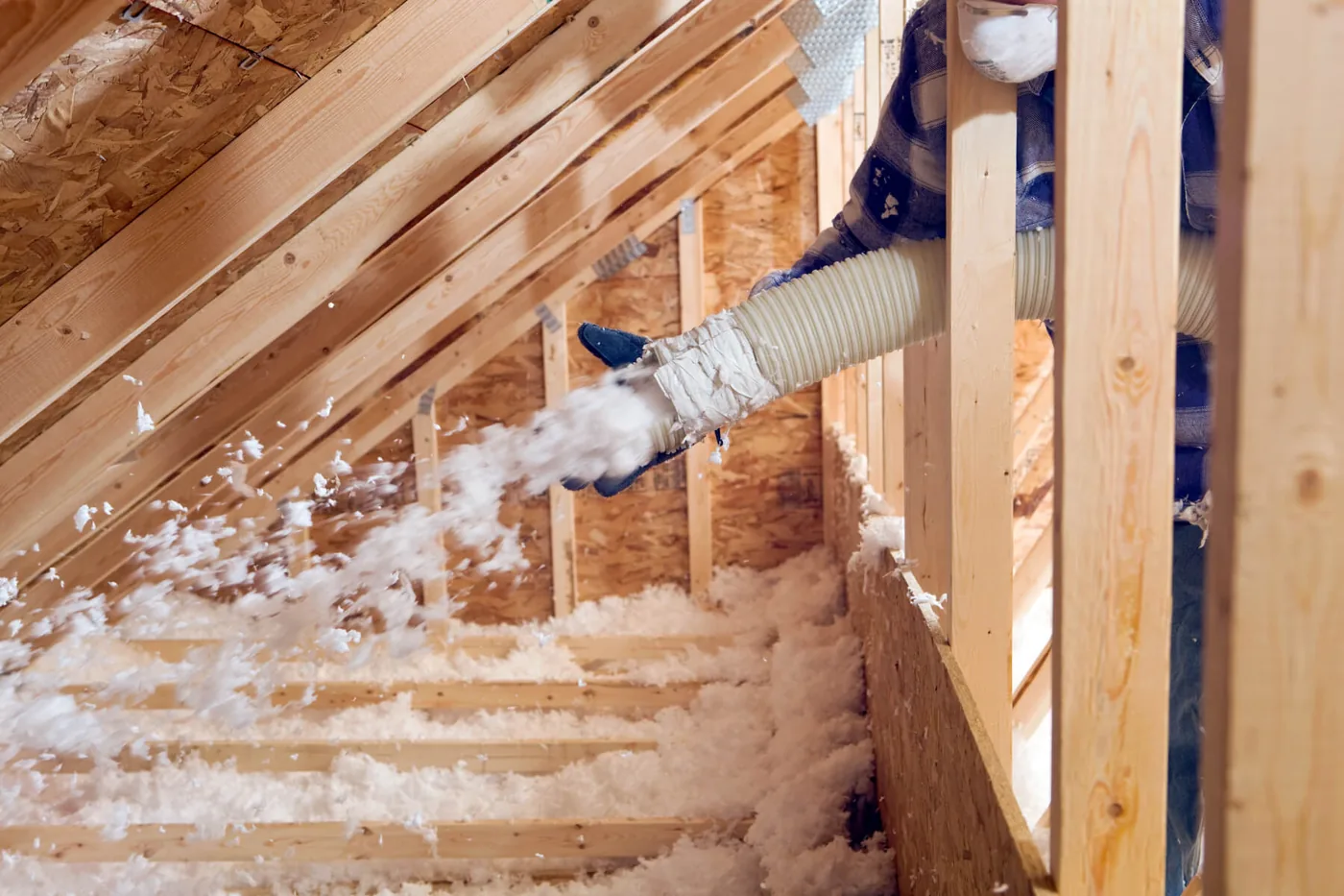Blown-in insulation evenly covering an attic floor